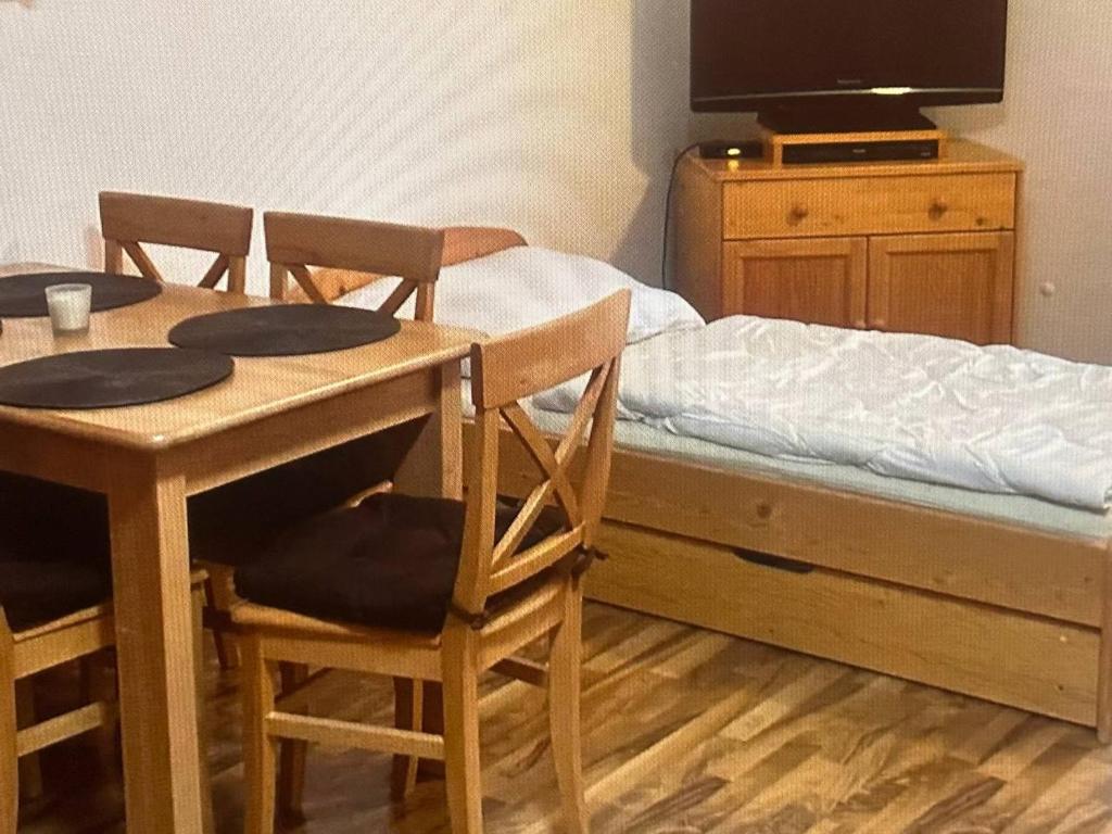 a bedroom with a bed and a table and chairs at Mountain Deluxe in Ružomberok