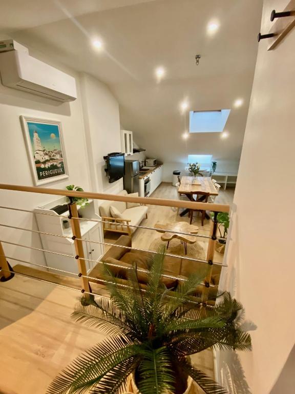 un salon avec un escalier et une table dans l'établissement Le LOFT du CENTRE HISTORIQUE, à Périgueux