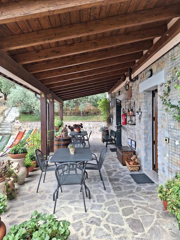 a patio with a table and chairs under a wooden roof at B&B Le Terrazze in Perugia