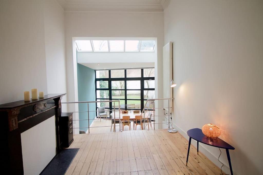 a living room with a table and a dining room at Amazing 3 bedrooms - Place Brugmann in Brussels