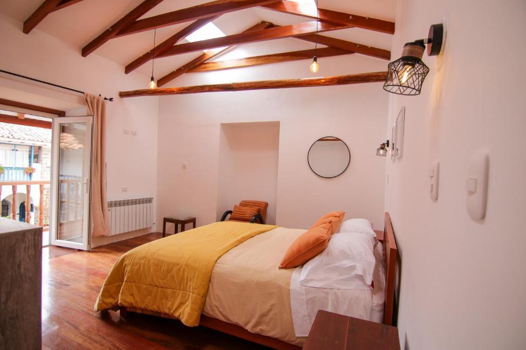 un dormitorio con una cama en una habitación en QORI, apartamento nuevo Centro Histórico de Cusco, Cuesta San Blas 561, en Cusco