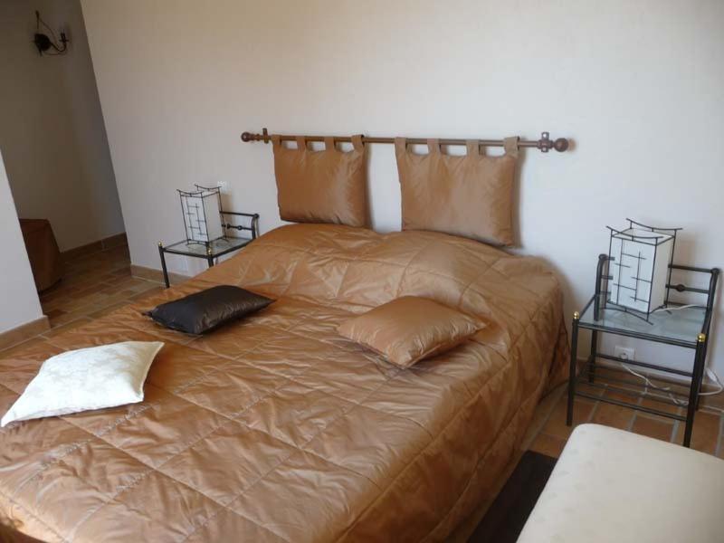 a large bed with two pillows on it in a room at Chambre d&#39;hôtes &quot;La Bastide des Eucalyptus&quot; in Antibes