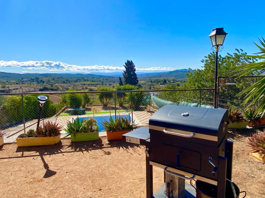 a bbq grill on a patio with a view at Beautiful Villa with huge private pool and vineyard view in Valencia