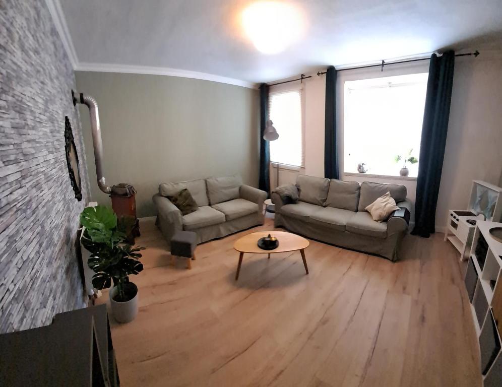 a living room with a couch and a table at XL Large & Cozy 2 bedroom Apartment nearly Hallstatt & Bad Ischl in Bad Goisern