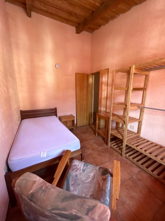 a room with two bunk beds and a desk at CasaDolomiti Coban Guest House in Cobán
