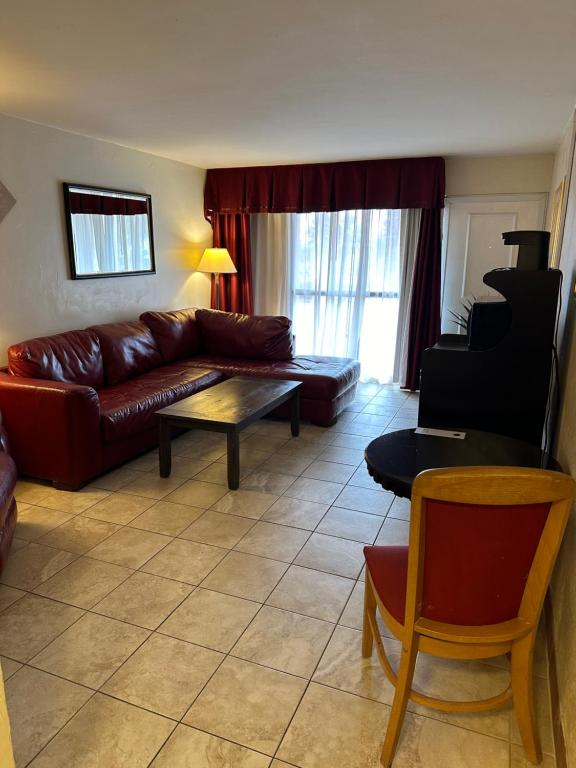 a living room with a couch and a table at Ramada by Wyndham Las Cruces Hotel & Conference Center in Las Cruces