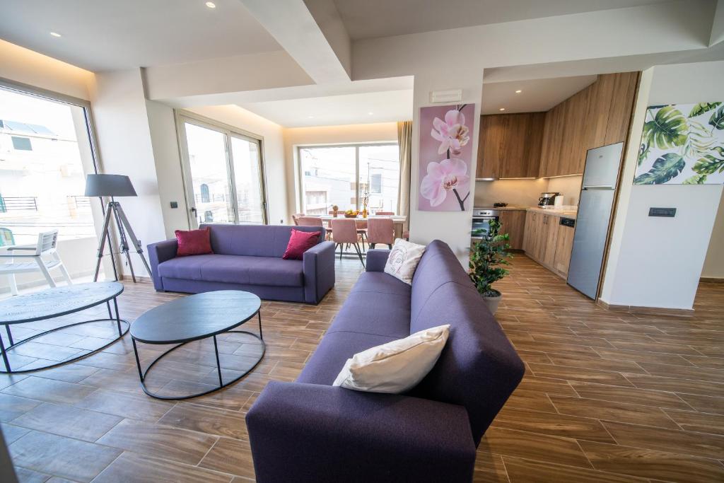 a living room with a purple couch and a table at Luxury House - Hersonissos Center - Sleeps 8 in Hersonissos