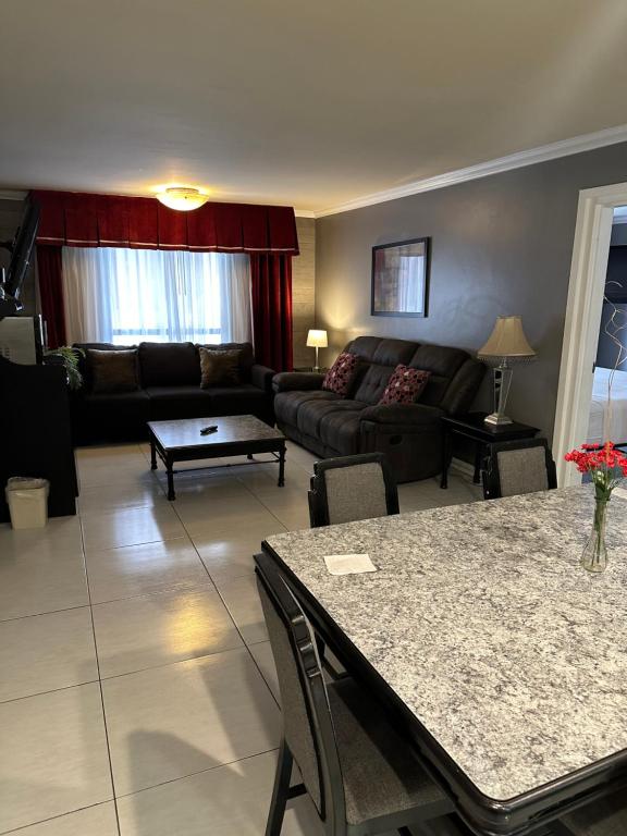 a living room with a couch and a table at Ramada by Wyndham Las Cruces Hotel & Conference Center in Las Cruces