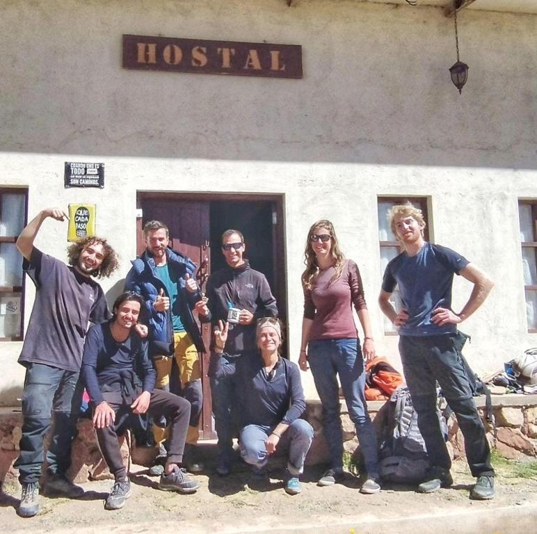 a group of people posing for a picture in front of a building at Hostal Casona Don Ranulfo in Peñas