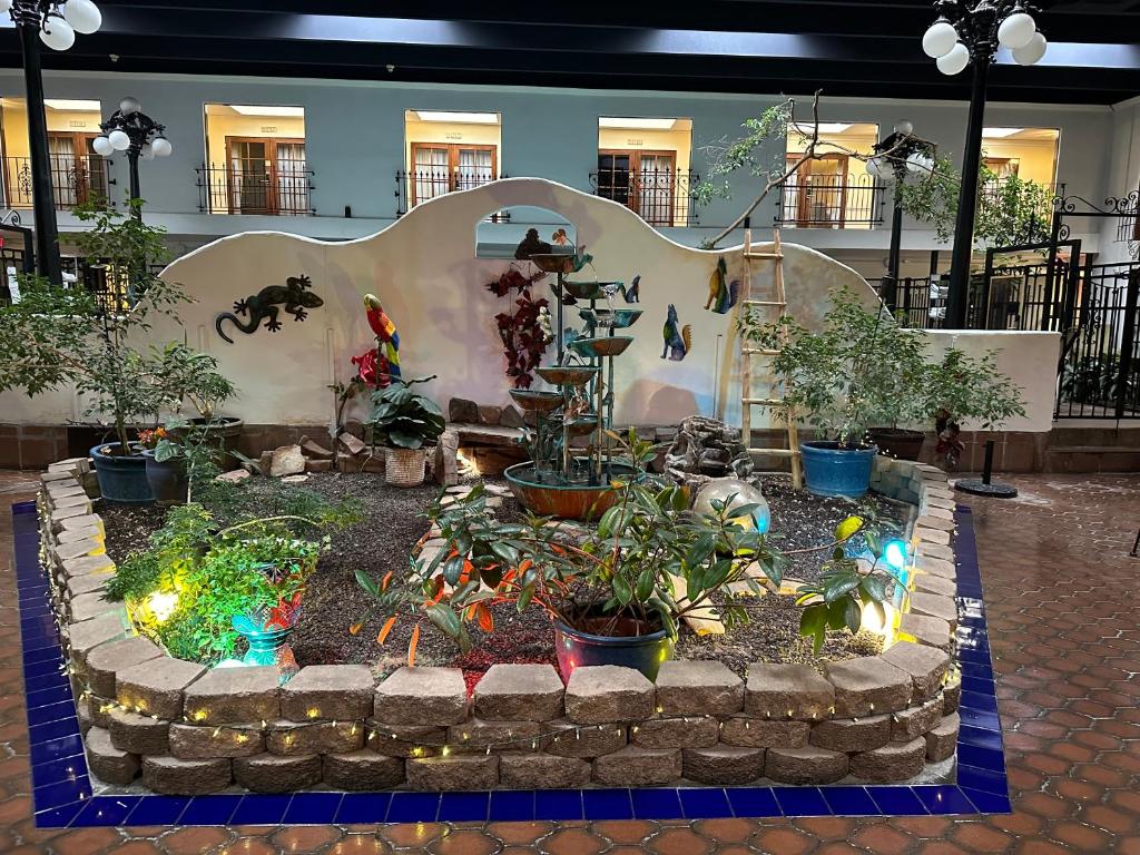 a garden with plants and lights in a building at Ramada by Wyndham Las Cruces Hotel & Conference Center in Las Cruces