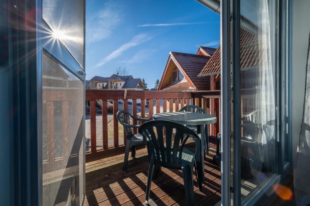 a patio with a table and chairs on a balcony at Apartmán Andy Riviera 503-10 Lipno Home in Lipno nad Vltavou