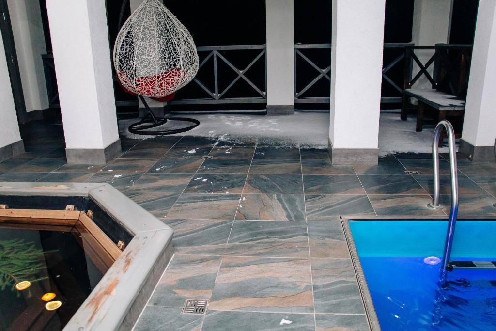 a plunge pool in the middle of a house with a swing at Ехо Тростяну in Slavske