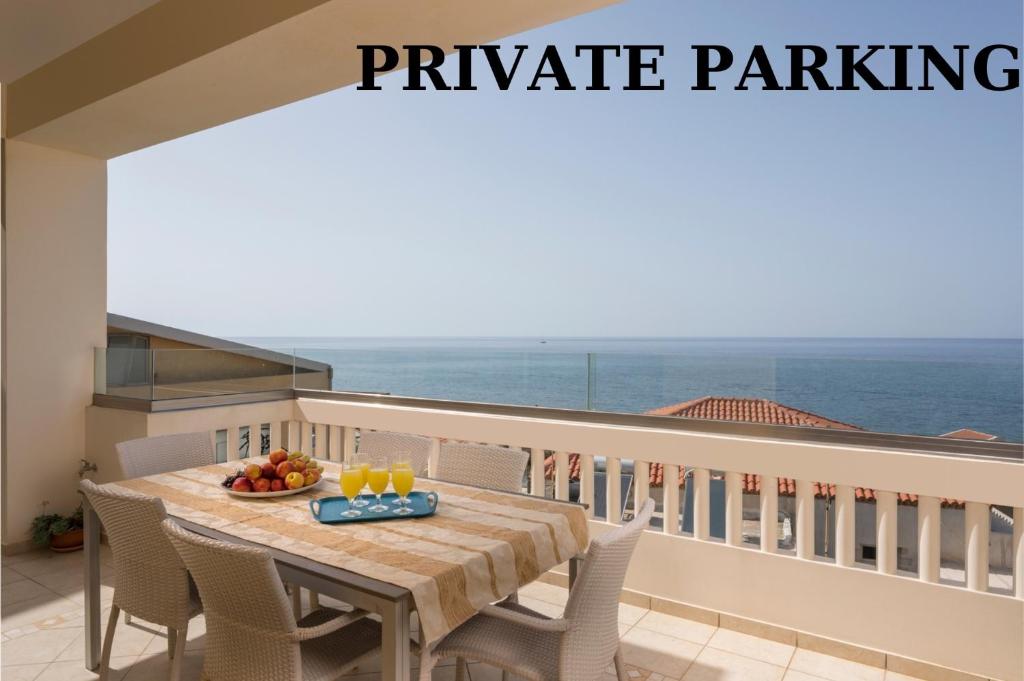 a table and chairs on a balcony with the ocean at Vaggelio House in Chania