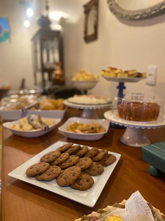 a table with cookies and other food on it at Pousada Mãe Natureza in Pirenópolis
