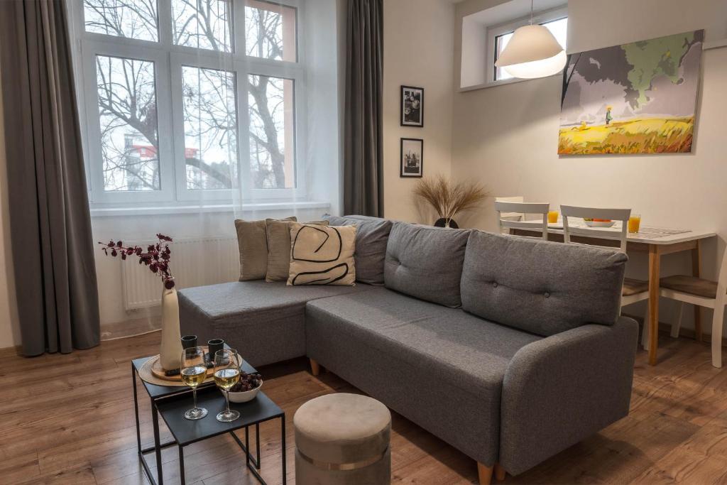 a living room with a couch and a table at Apartmán u Výstaviště in Olomouc