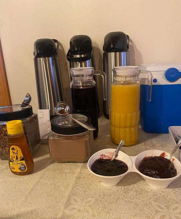 a counter with two bowls of food and some juice at Pousada Mãe Natureza in Pirenópolis