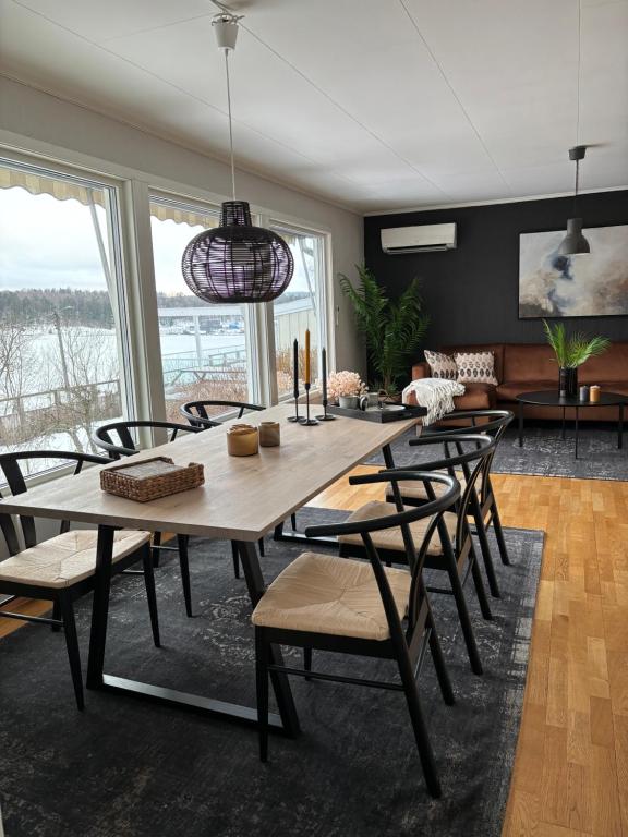 a dining room with a wooden table and chairs at Koslig bolig med sjøutsikt in Asker