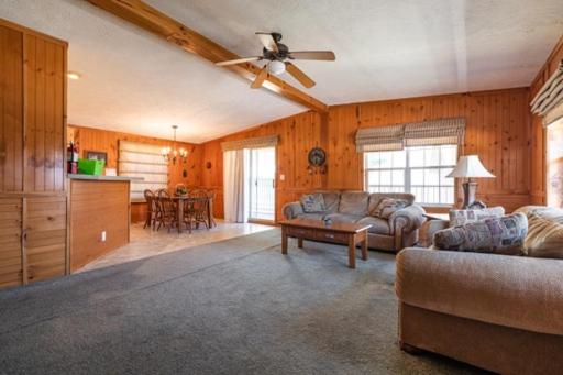 a living room with a couch and a ceiling fan at 6 Guests 3br, Fully Furnished, On-site Enjoyment in Neillsville