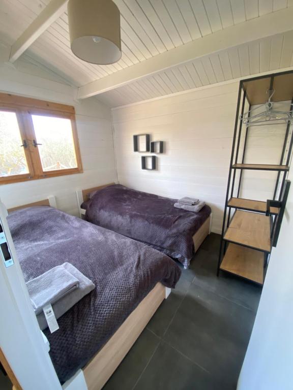 a bedroom with two beds and a ladder at Big Fish River Ebro Resort in Riba-roja d'Ebre