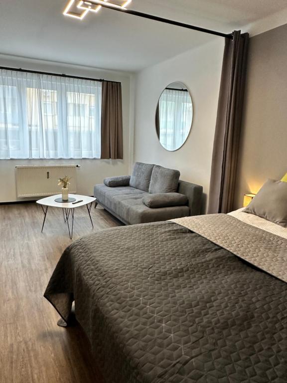 a hotel room with a bed and a couch at Harmony Living - Graz Stadion Liebenau in Graz