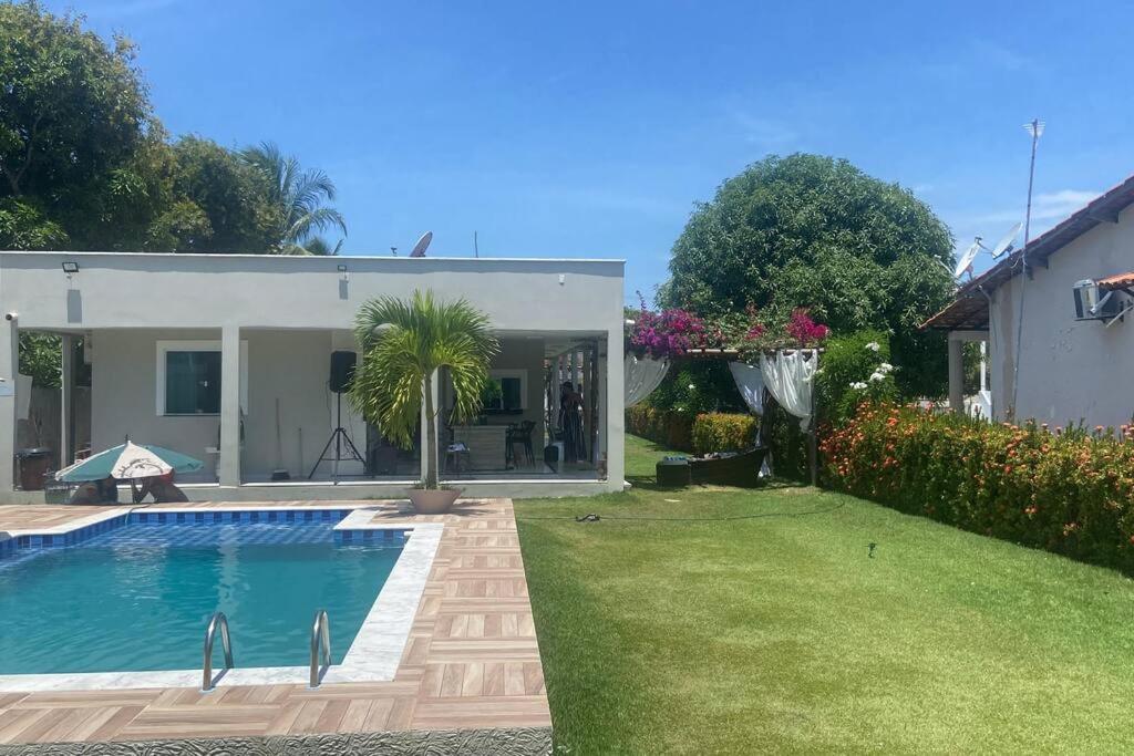 a house with a swimming pool in a yard at Casalagorios - ilha de Itaparica - Berlinque in Vera Cruz de Itaparica