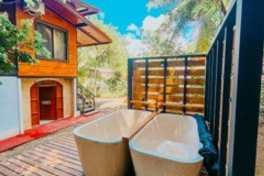 a bath tub sitting on top of a balcony at Casa sin Tiempo in Uvita