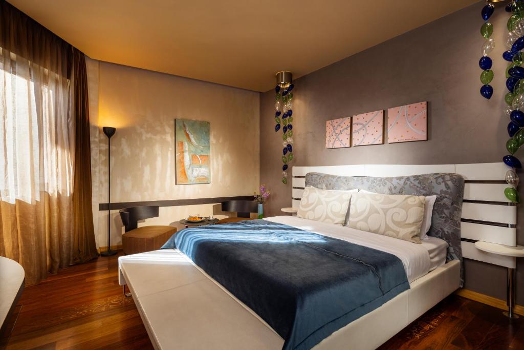 a bedroom with a large bed in a room at Les Fleurs Boutique Hotel in Sofia