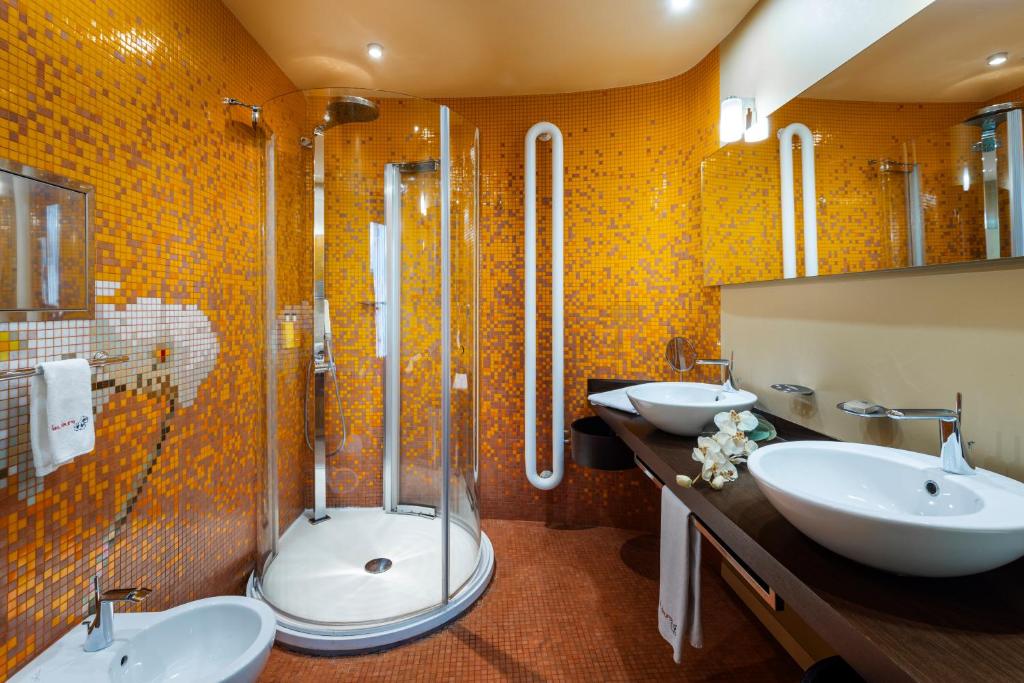 a bathroom with two sinks and a shower at Les Fleurs Boutique Hotel in Sofia