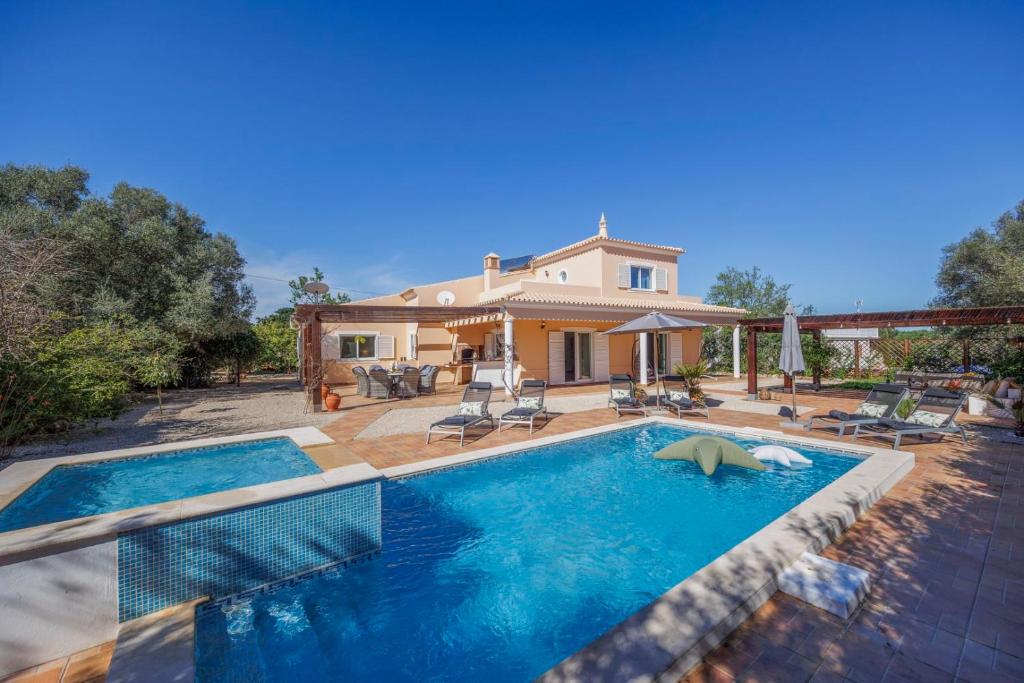 a house with a swimming pool in front of a house at Beautiful Countryside Villa w Private Garden and Pool in Alte
