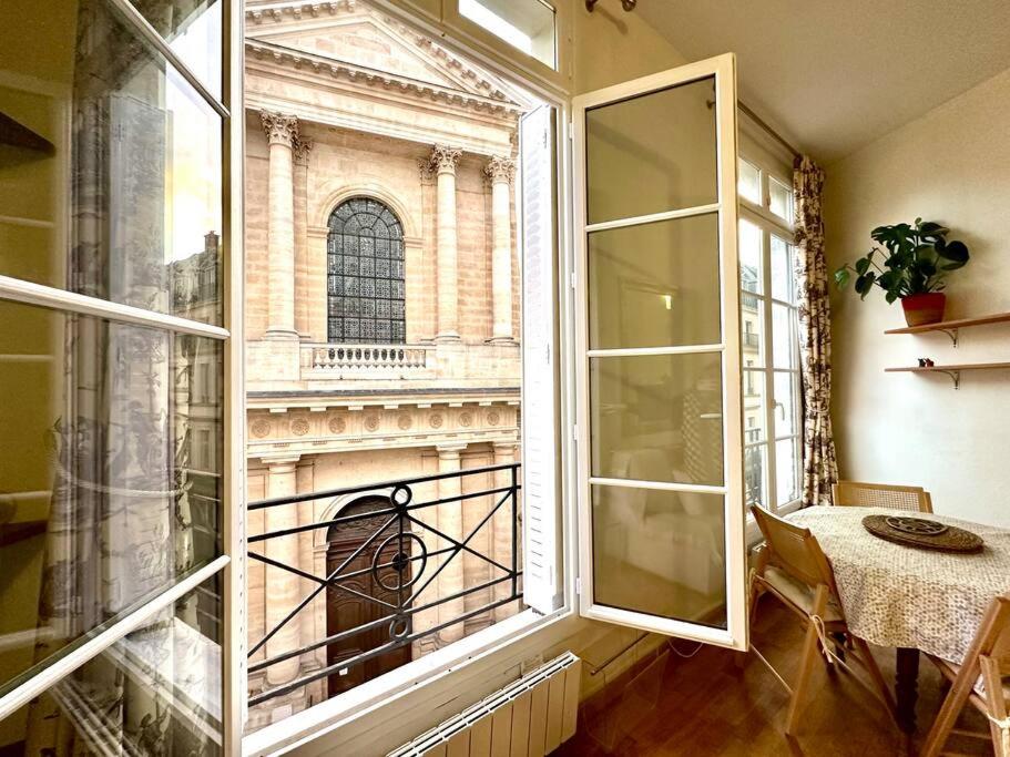 a room with a window with a view of a building at Superbe appartement hyper centre de Paris in Paris
