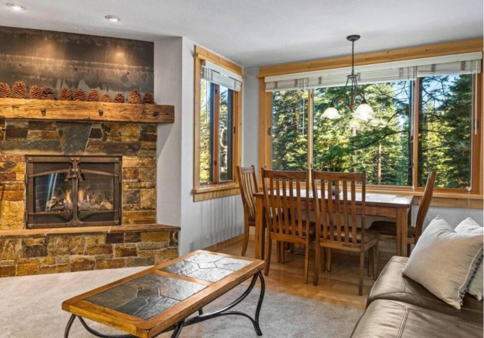 a living room with a fireplace and a dining table at Northstar Ski Trails Condo Walk to Village 3 Year-Round Hot Tubs in Rec. Center in Truckee