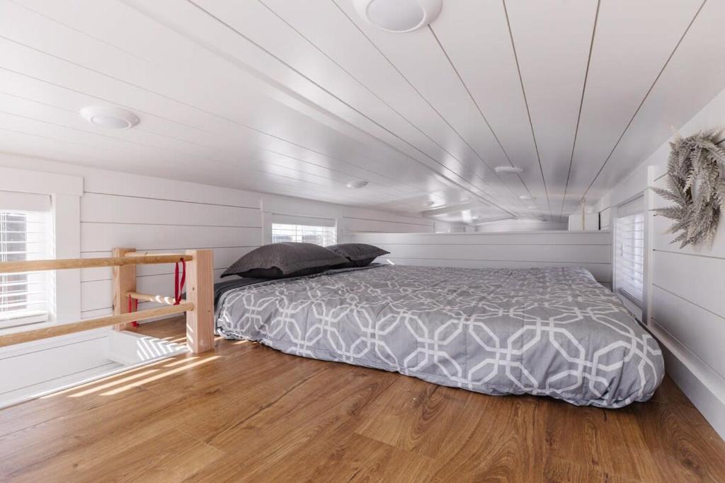 A bed or beds in a room at The Narrows Tiny Home