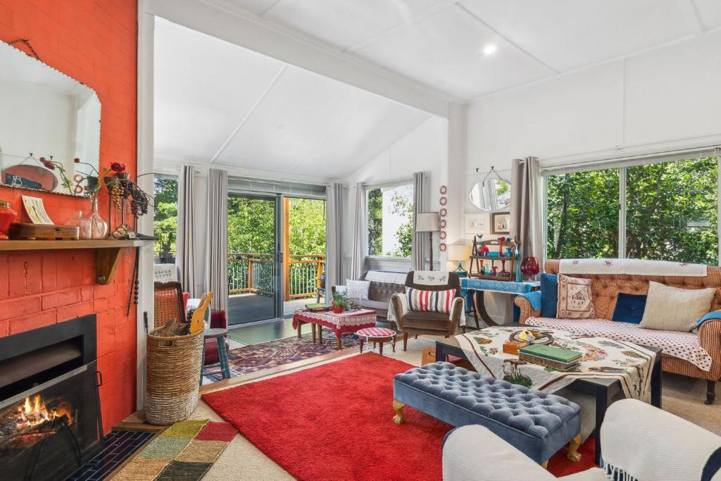 a living room filled with furniture and a fireplace at The Cottage in Blackheath