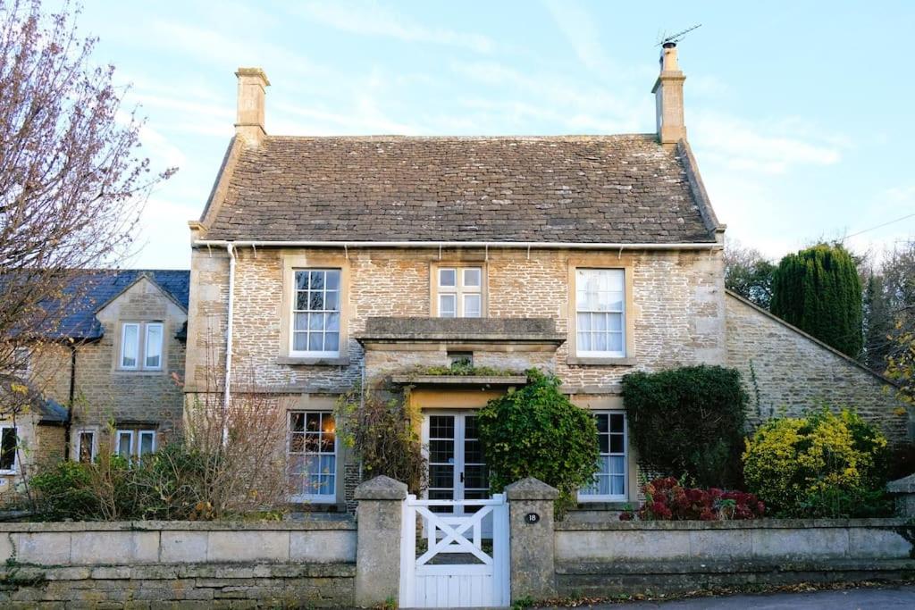 une vieille maison en briques avec une clôture devant elle dans l'établissement 17th Century Rural Home, à Hawthorn