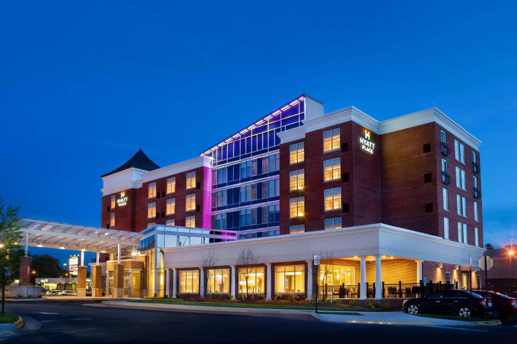 a large building with lights on in a street at Hyatt Place Fredericksburg at Mary Washington in Fredericksburg