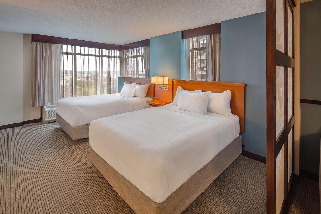 a hotel room with two beds and two windows at Hyatt Place Madison/Downtown in Madison