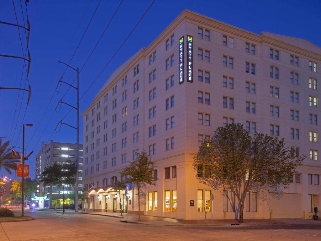 a large white building on a city street at night at Hyatt Place New Orleans Convention Center in New Orleans