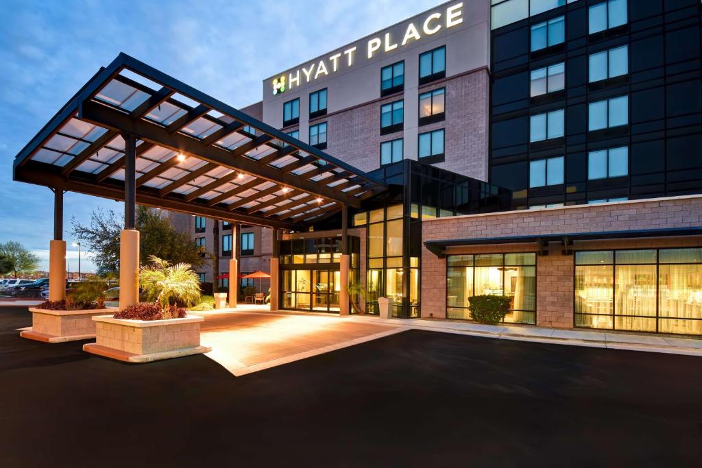 an entrance to a hotel with a large building at Hyatt Place Phoenix Gilbert in Gilbert