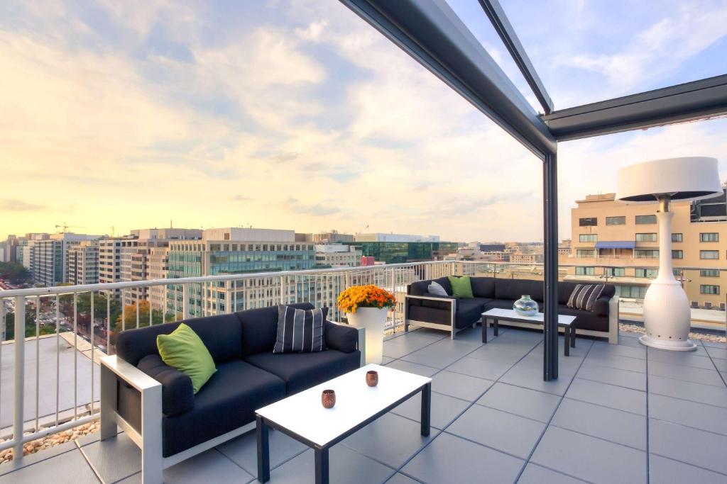 a balcony with couches and a view of a city at Hyatt Place Washington DC/White House in Washington, D.C.