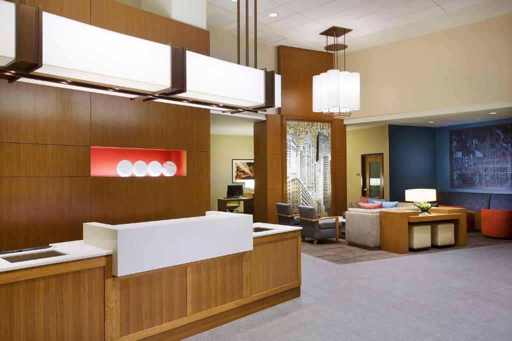 an office lobby with a reception desk and a waiting room at Hyatt Place Chicago Midway Airport in Bedford Park