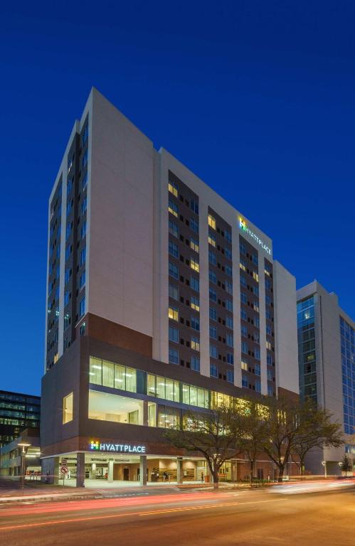 a large building with lights on in a city at Hyatt Place Houston Galleria in Houston