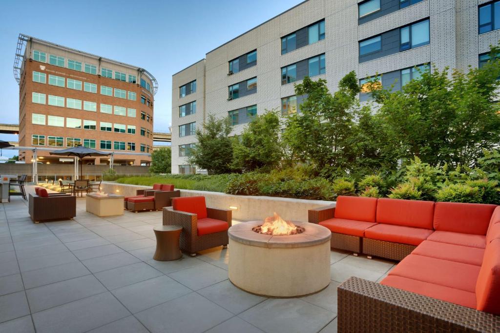 a patio with couches and a fire pit and buildings at Hyatt House Portland / Downtown in Portland