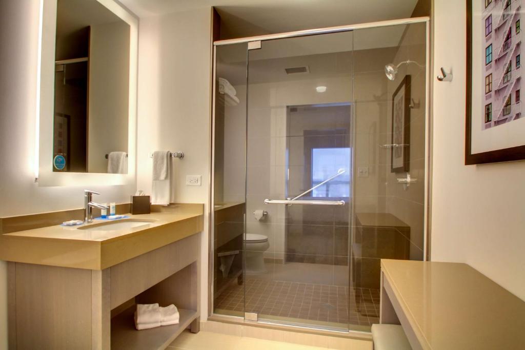 a bathroom with a shower and a sink and a toilet at Hyatt House Chicago/Evanston in Evanston