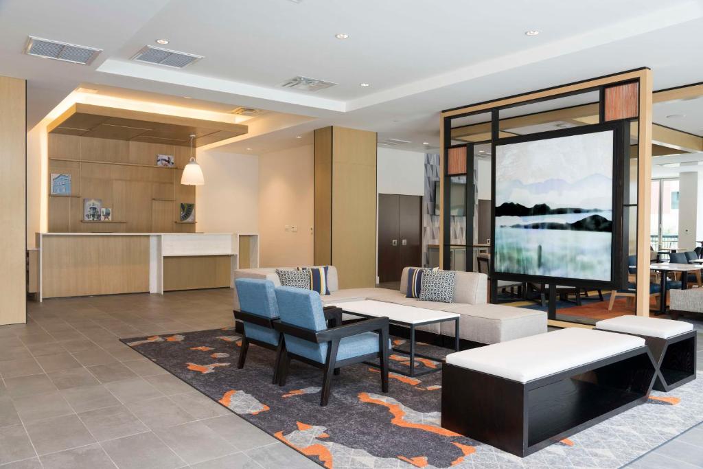 a lobby with a table and chairs and a kitchen at Hyatt House Austin/Downtown in Austin