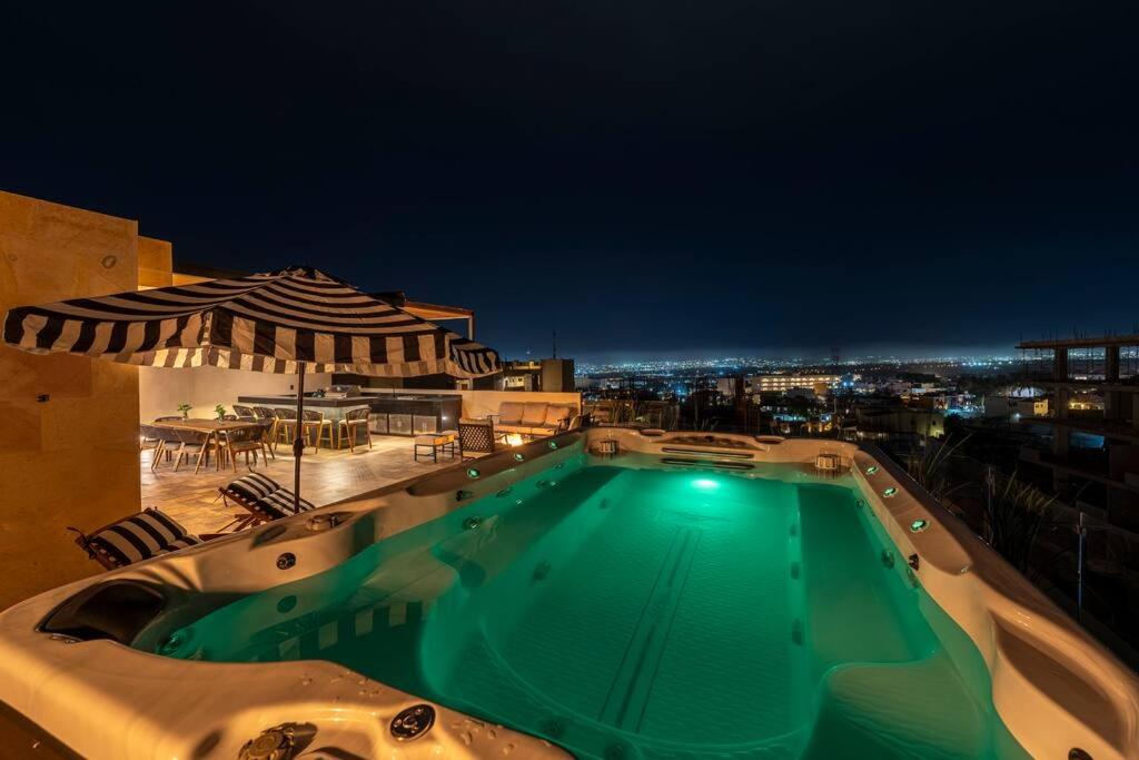 a swimming pool on top of a building at night at Villa San Lucas - Luxury 4BR Penthouse in Cabo San Lucas