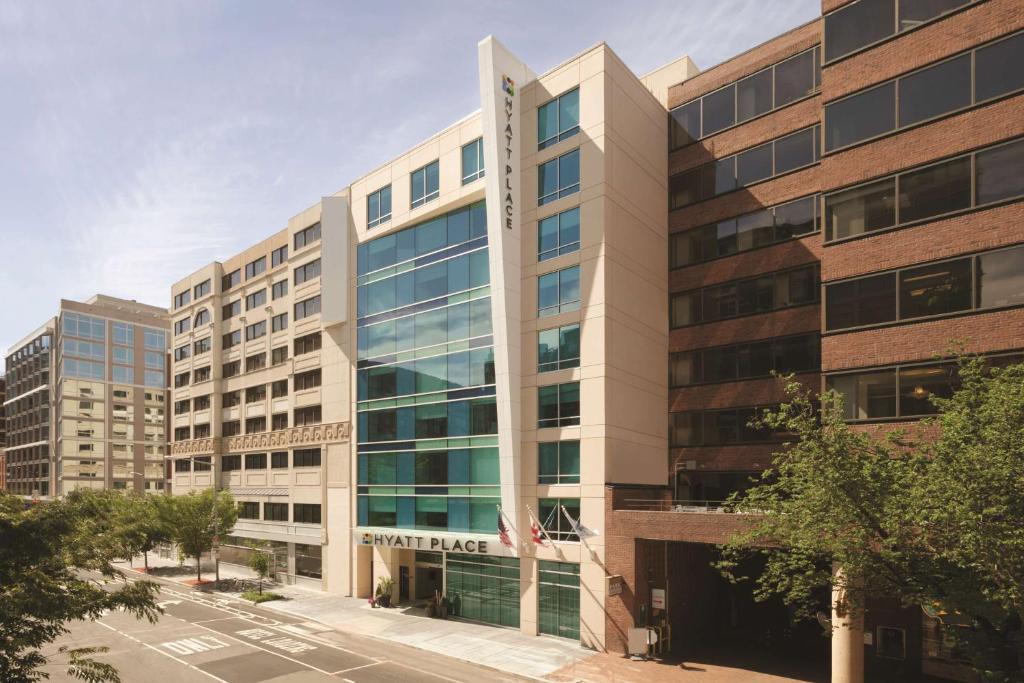 a large building with glass windows on a city street at Hyatt Place Washington DC/Georgetown/West End in Washington