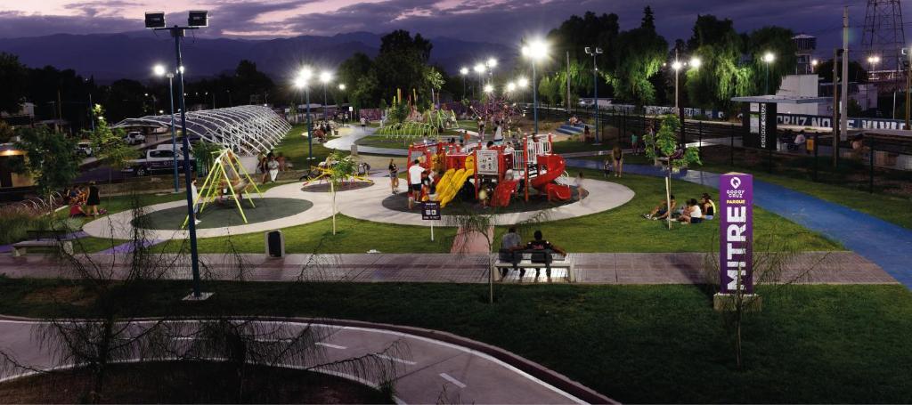 a park with a playground with people in it at night at DPTO PLAZA GODOY CRUZ in Godoy Cruz
