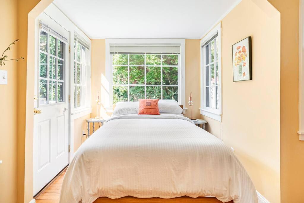 a large bed in a room with windows at Secret Garden Stay - Perfect SF Location in San Francisco