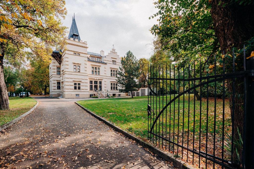 an old mansion with a gate in front of it at Vila Austerlitz in Slavkov u Brna