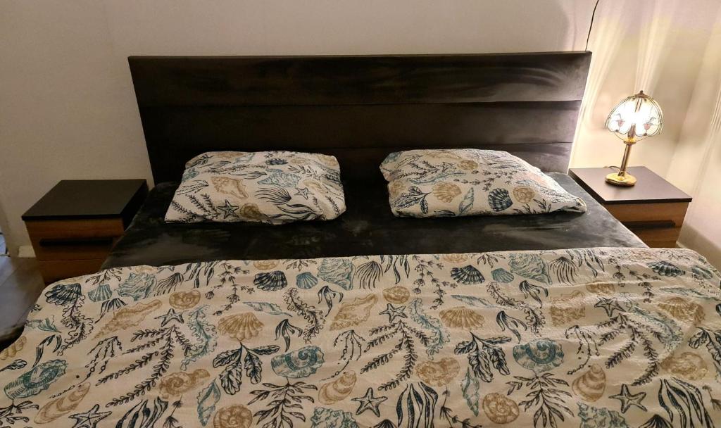 a bed with two pillows on it in a bedroom at Apartment for Rent in Gjilan